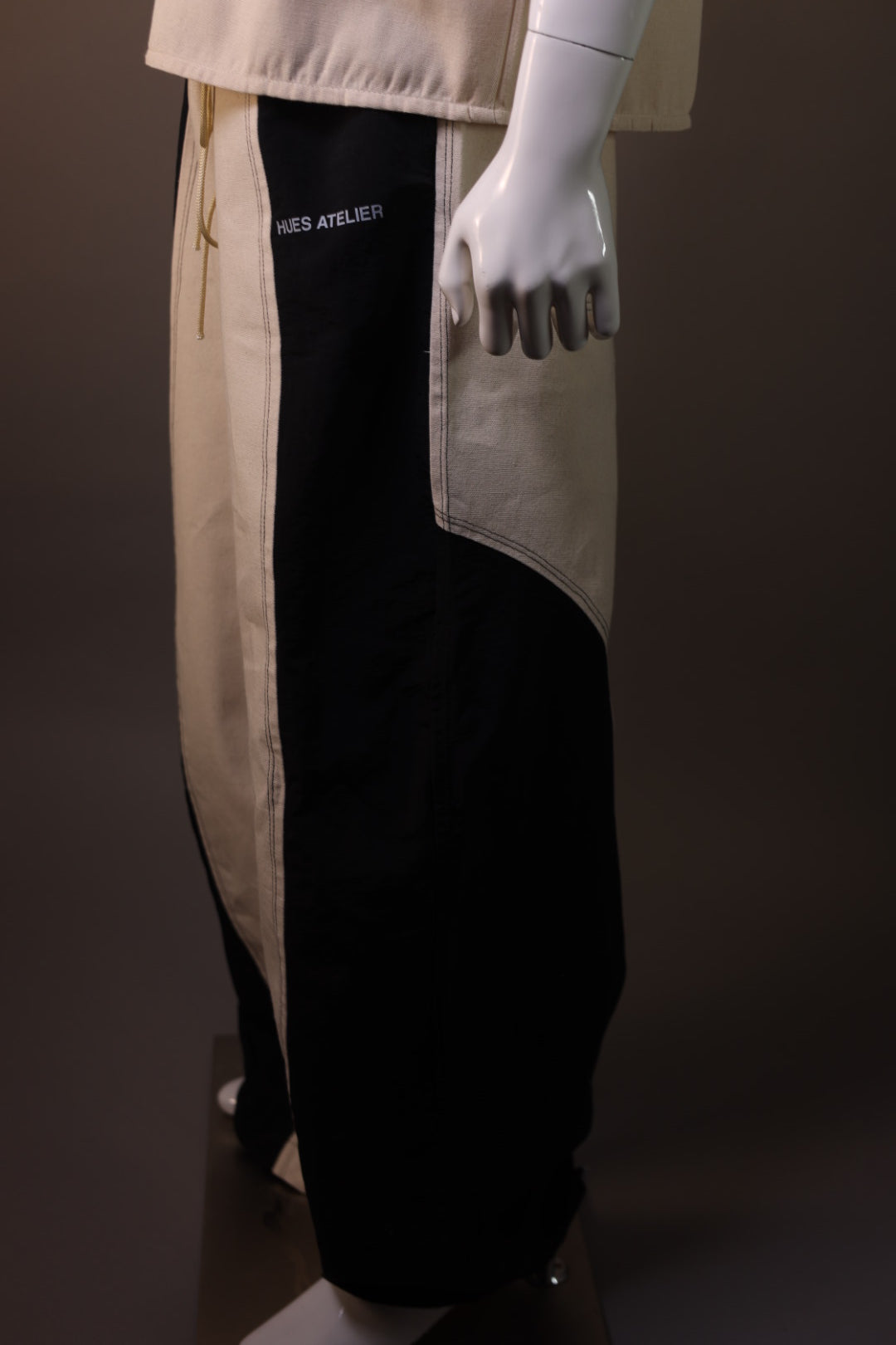 Hues Atelier Track pants two different materials blended.