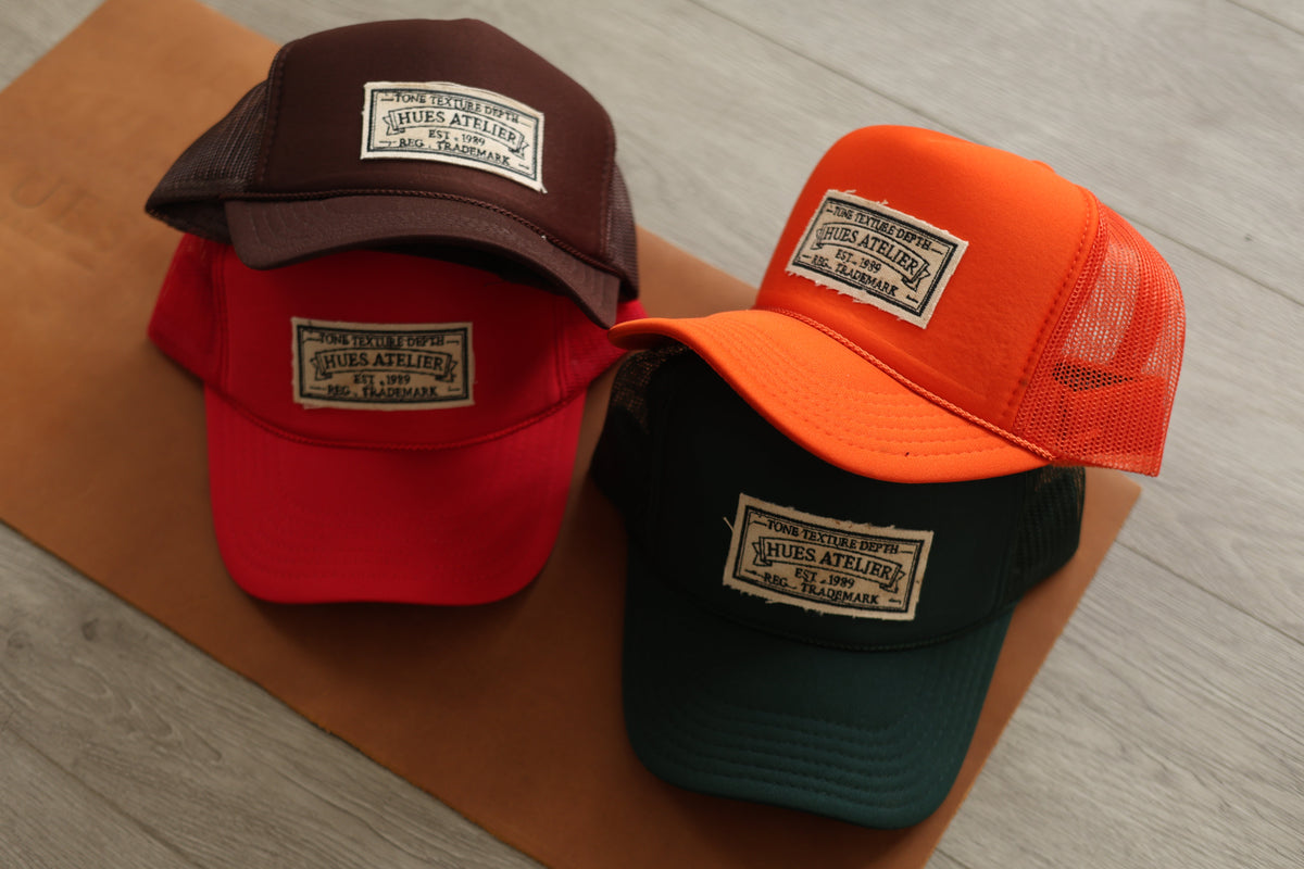 Hues Atelier Trucker Hats displayed in multiple colorways
