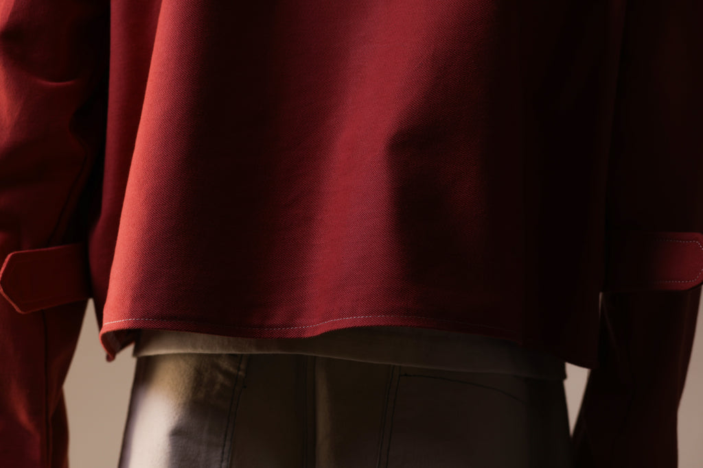 Close-up of a person wearing a red garment with a blurred background