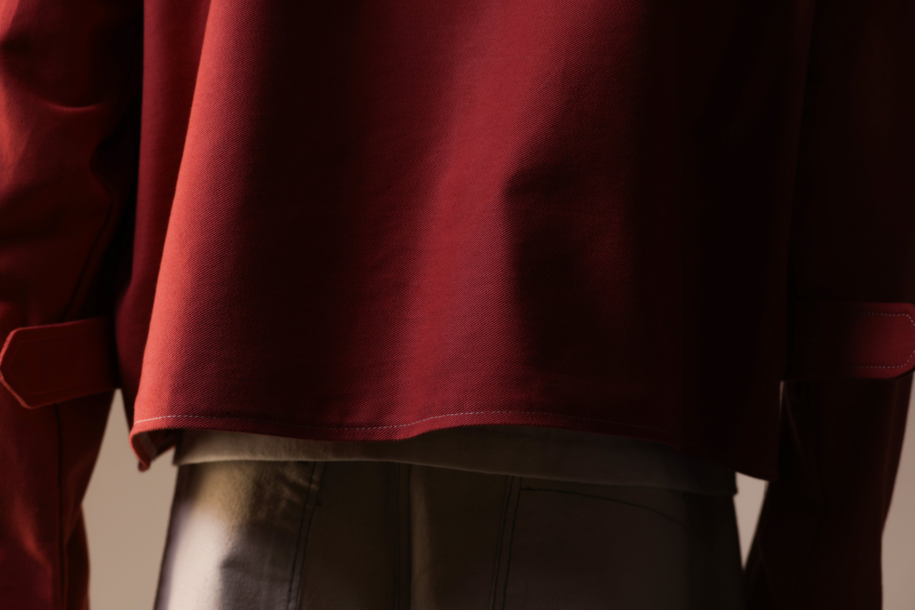 Close-up of a person wearing a red garment with a blurred background