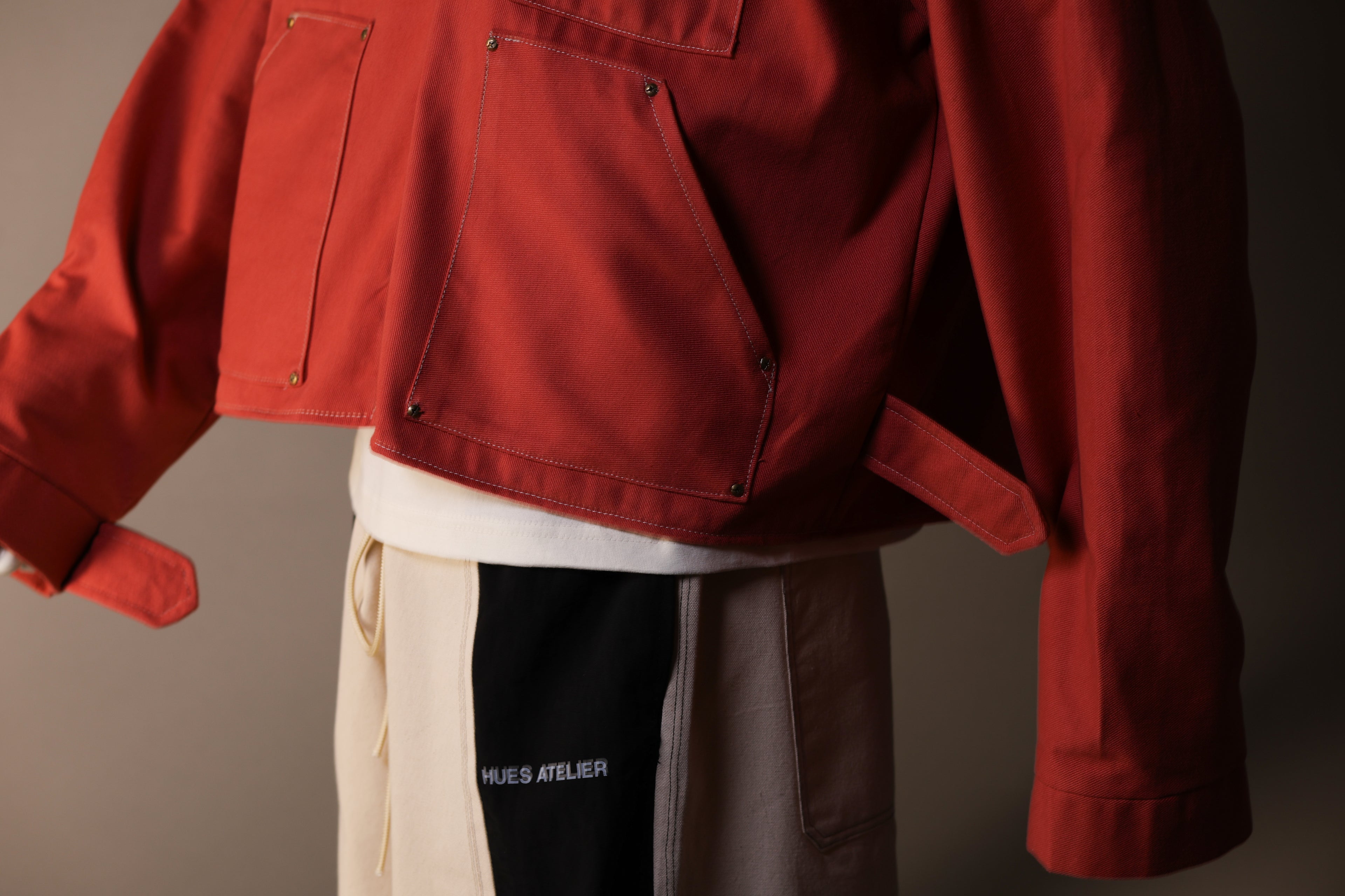 Red jacket worn by a person with a neutral background