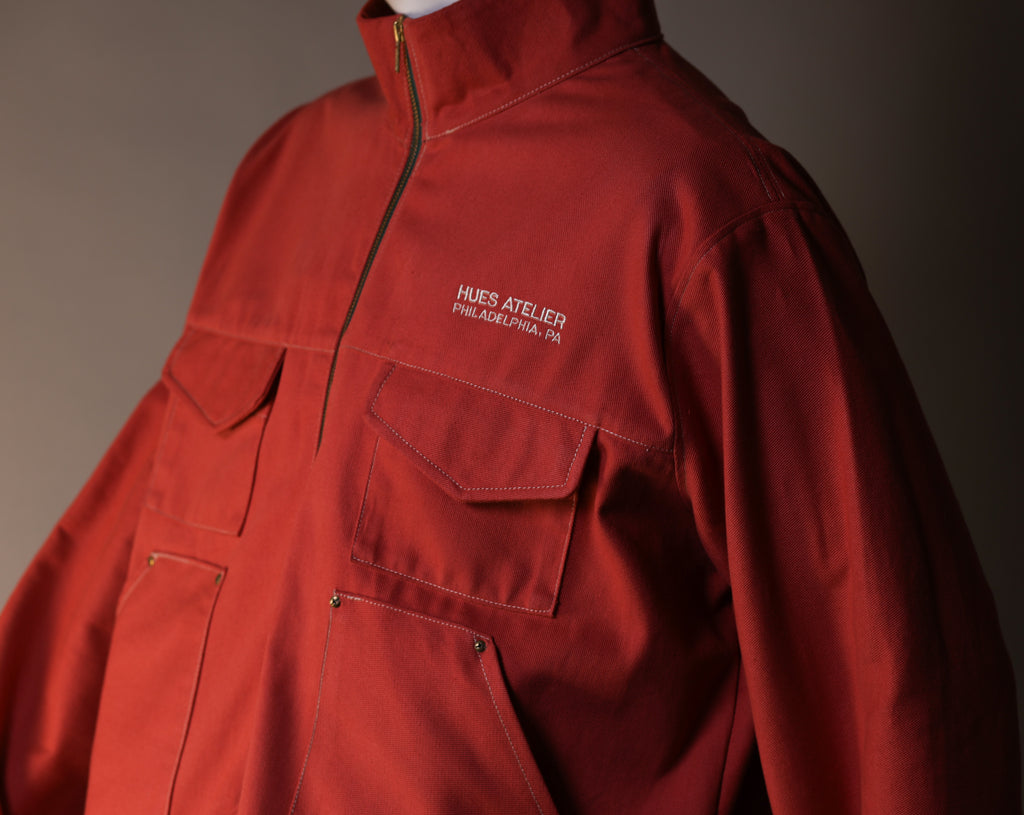 Red jacket with a brand logo on a dark background