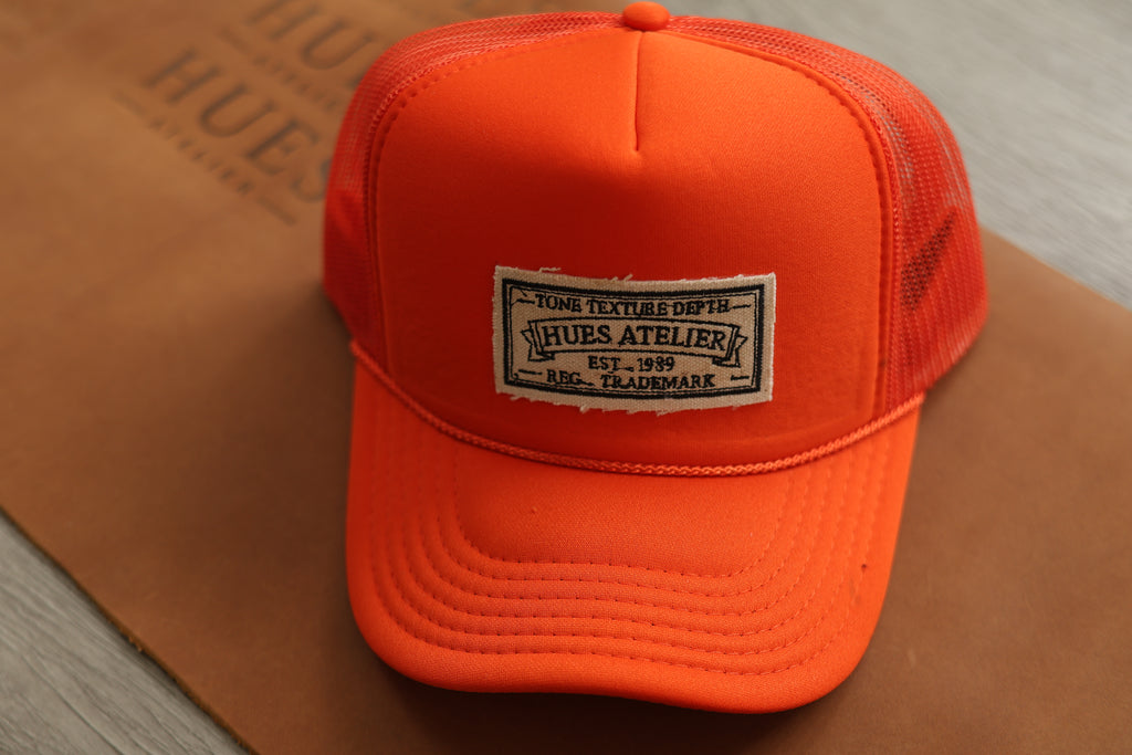 Orange Hues Atelier Trucker Hat with embroidered logo patch