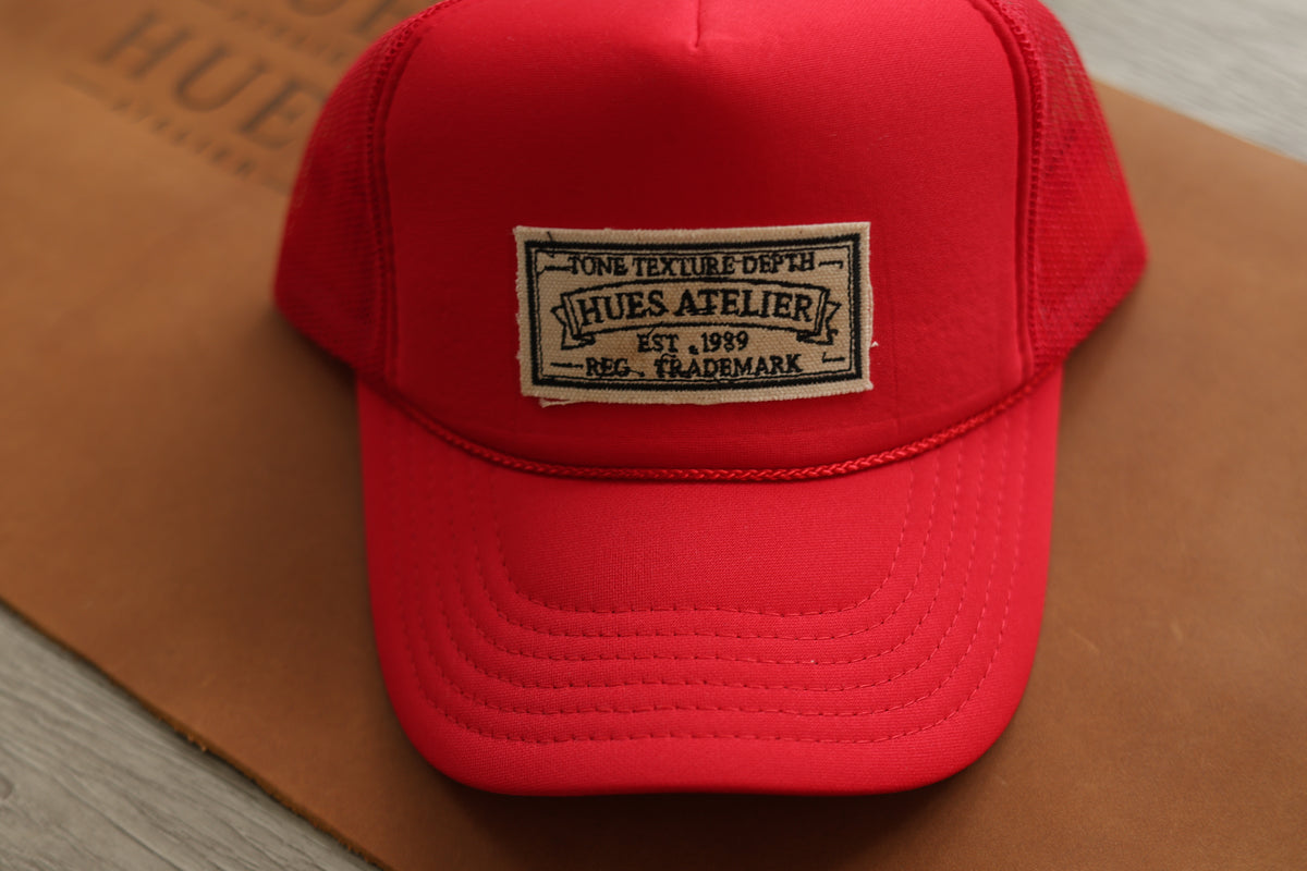 Red Hues Atelier Trucker Hat with embroidered front patch
